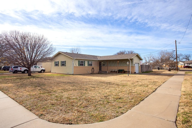 ranch-style house with a front lawn