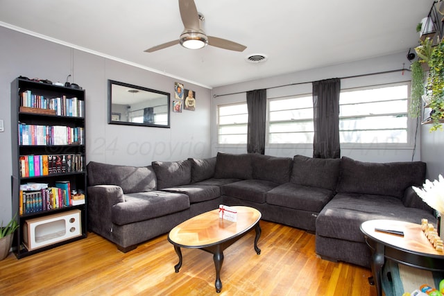 living room featuring ceiling fan, crown molding, and hardwood / wood-style flooring