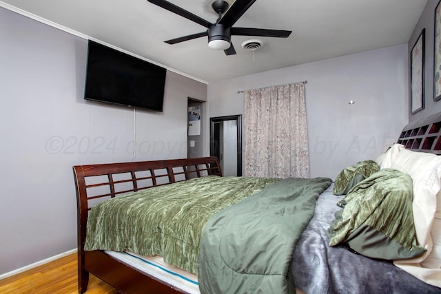 bedroom with hardwood / wood-style floors and ceiling fan