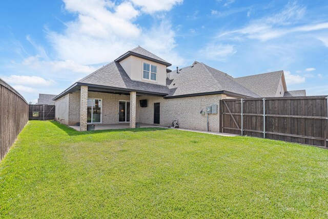 5504 Wesley Dr, Amarillo, TX 79119 - back of property with brick siding, a shingled roof, a patio area, and a fenced backyard