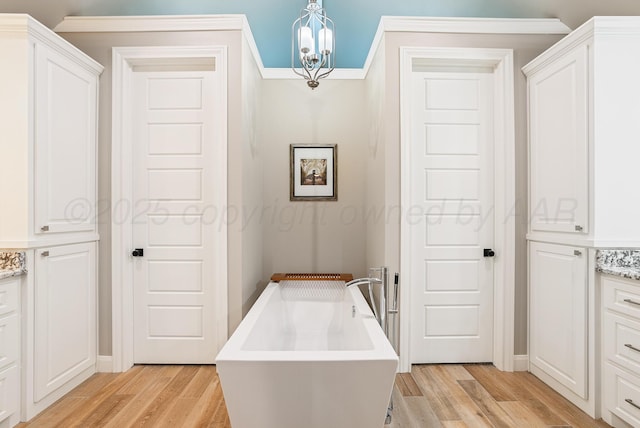 5504 Wesley Dr, Amarillo, TX 79119 - hallway with light wood-type flooring, a chandelier, and ornamental molding