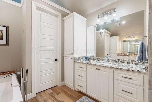 5504 Wesley Dr, Amarillo, TX 79119 - full bath with vanity and wood finished floors