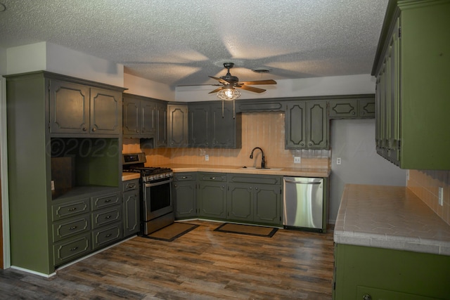 301 Maple Ave, Panhandle, TX 79068 - kitchen with appliances with stainless steel finishes, ceiling fan, dark wood finished floors, backsplash, and a textured ceiling