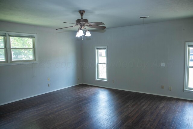 301 Maple Ave, Panhandle, TX 79068 - empty room featuring dark wood-style flooring and a ceiling fan