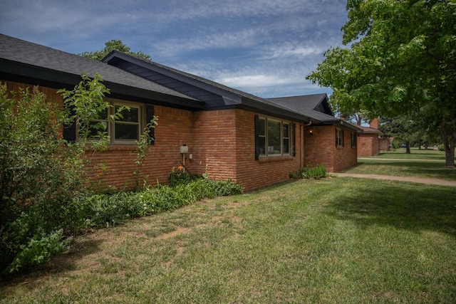 301 Maple Ave, Panhandle, TX 79068 - view of property exterior with brick siding, a yard, and a shingled roof