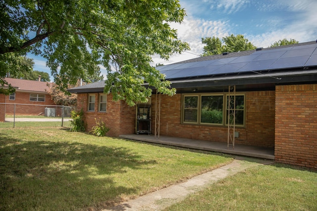 301 Maple Ave, Panhandle, TX 79068 - rear view of house featuring brick siding and solar panels