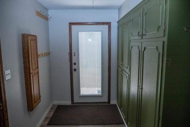 301 Maple Ave, Panhandle, TX 79068 - doorway with baseboards and dark wood finished floors