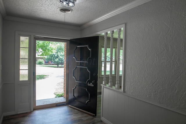 301 Maple Ave, Panhandle, TX 79068 - entryway with a textured ceiling, a textured wall, wood finished floors, a wainscoted wall, and crown molding