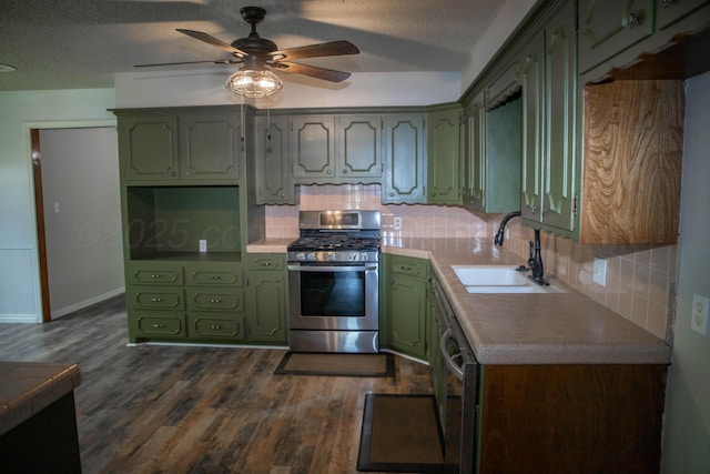 301 Maple Ave, Panhandle, TX 79068 - kitchen with appliances with stainless steel finishes, green cabinets, dark wood-style floors, decorative backsplash, and a textured ceiling