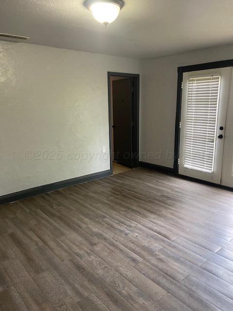 235 Cliffside Dr, Amarillo, TX 79118 - spare room with wood finished floors and baseboards