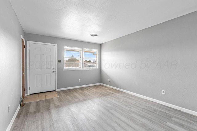 3302 Sequoia St, Amarillo, TX 79107 - empty room with wood finished floors and a textured ceiling