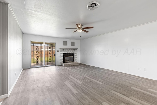 3302 Sequoia St, Amarillo, TX 79107 - unfurnished living room featuring a ceiling fan, wood finished floors, and a fireplace