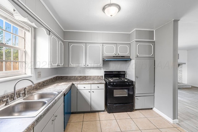 3302 Sequoia St, Amarillo, TX 79107 - kitchen with gas stove, under cabinet range hood, light tile patterned floors, and dishwashing machine