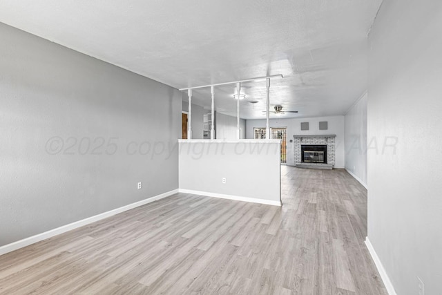 3302 Sequoia St, Amarillo, TX 79107 - unfurnished living room with ceiling fan, wood finished floors, and a fireplace