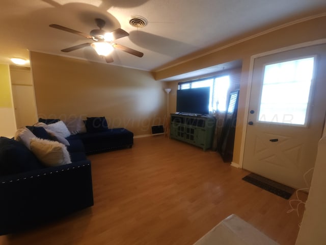 2706 Magnolia St, Amarillo, TX 79107 - living area with ornamental molding, ceiling fan, and light wood-style flooring