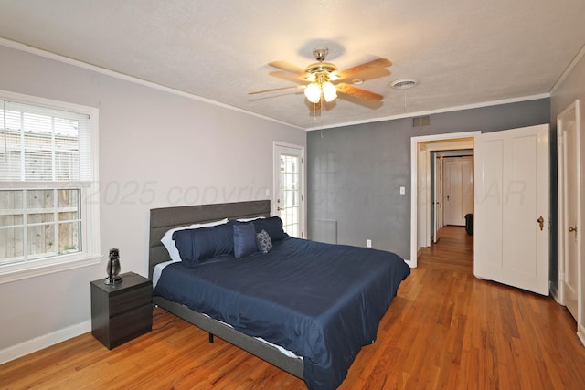 bedroom featuring baseboards, multiple windows, light wood-style flooring, and visible vents