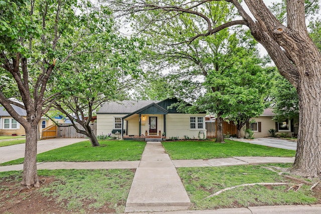 view of front of property featuring a gate, fence, a front lawn, and concrete driveway
