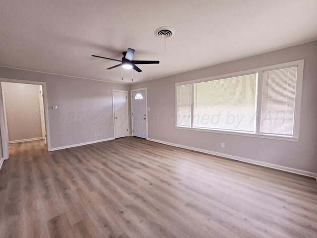 4301 S Washington St, Amarillo, TX 79110 - unfurnished living room with wood finished floors, plenty of natural light, and a ceiling fan