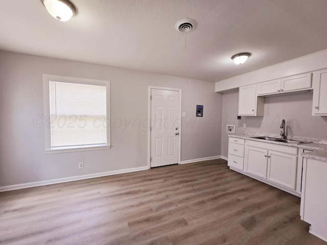 4301 S Washington St, Amarillo, TX 79110 - kitchen with white cabinets and wood finished floors