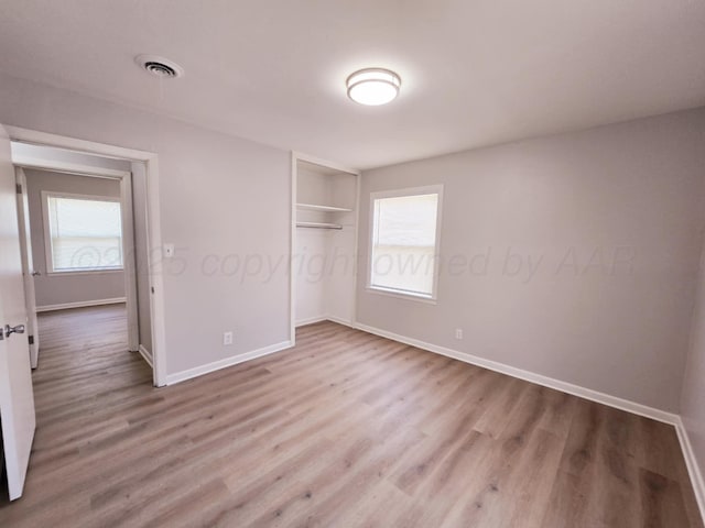 4301 S Washington St, Amarillo, TX 79110 - unfurnished bedroom with multiple windows and wood finished floors