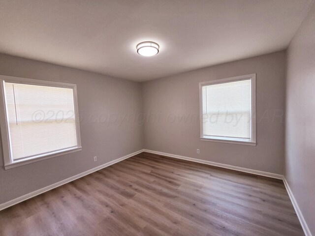 4301 S Washington St, Amarillo, TX 79110 - spare room with dark wood-style floors and baseboards