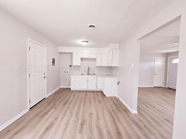 4301 S Washington St, Amarillo, TX 79110 - kitchen featuring light wood finished floors, light countertops, and white cabinets