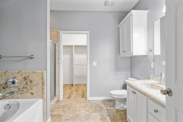 9317 Shylana Ave, Amarillo, TX 79119 - bathroom featuring vanity, a stall shower, a bath, a spacious closet, and tile patterned flooring