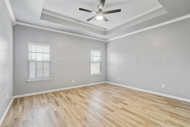 9317 Shylana Ave, Amarillo, TX 79119 - empty room with a raised ceiling, light wood-style flooring, ceiling fan, and crown molding