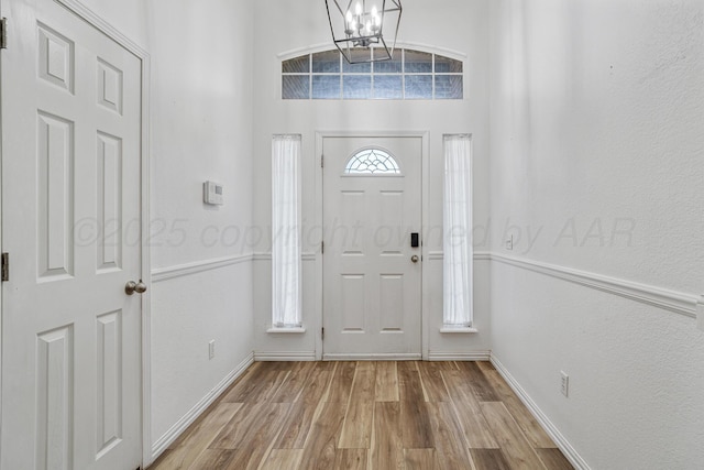 9317 Shylana Ave, Amarillo, TX 79119 - entryway with a chandelier, wood finished floors, and a textured wall