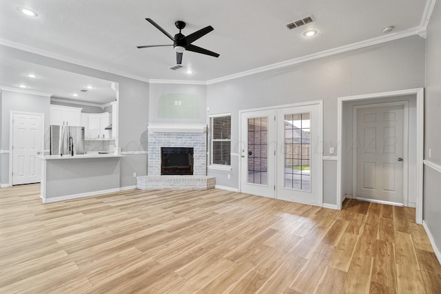 9317 Shylana Ave, Amarillo, TX 79119 - unfurnished living room featuring crown molding, light wood-style floors, ceiling fan, french doors, and recessed lighting