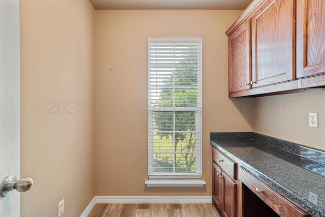 9317 Shylana Ave, Amarillo, TX 79119 - kitchen with brown cabinetry and light wood-style flooring