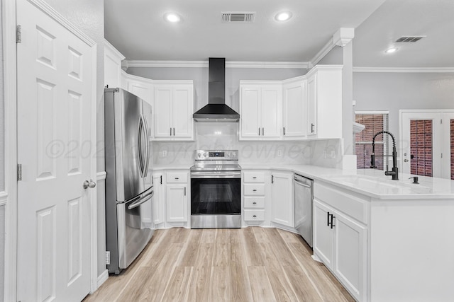 9317 Shylana Ave, Amarillo, TX 79119 - kitchen featuring stainless steel appliances, wall chimney range hood, a peninsula, light wood-style floors, and recessed lighting