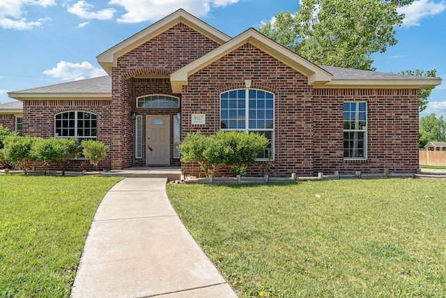 9317 Shylana Ave, Amarillo, TX 79119 - view of front of home featuring brick siding, a front yard, and roof with shingles