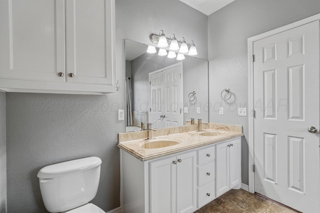 9317 Shylana Ave, Amarillo, TX 79119 - bathroom with double vanity, a textured wall, and tile patterned flooring