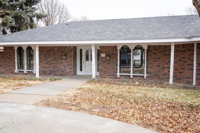 view of exterior entry with a porch