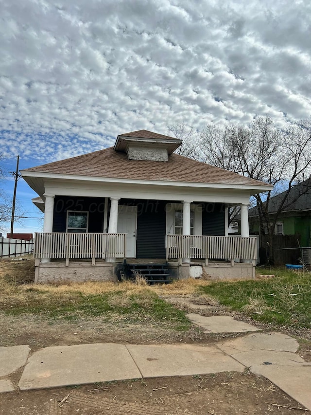 bungalow-style house with a porch and a shingled roof