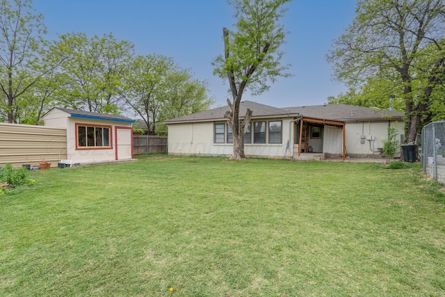 3519 S Julian Blvd, Amarillo, TX 79102 - back of property with a fenced backyard, an outbuilding, a lawn, and a shed