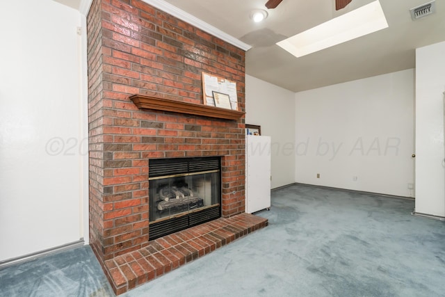 3519 S Julian Blvd, Amarillo, TX 79102 - unfurnished living room featuring visible vents, a brick fireplace, ceiling fan, carpet, and a skylight