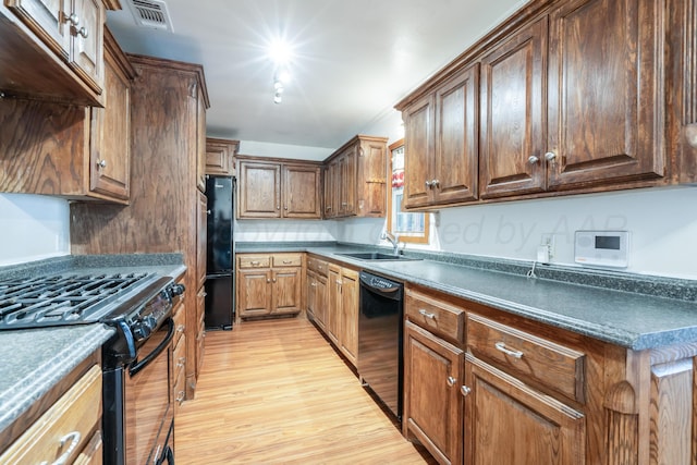 3519 S Julian Blvd, Amarillo, TX 79102 - kitchen featuring visible vents, dark countertops, a sink, light wood finished floors, and black appliances