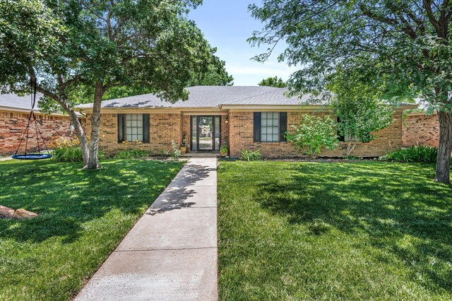 7703 Farrell Dr, Amarillo, TX 79121 - ranch-style house featuring a front yard and brick siding
