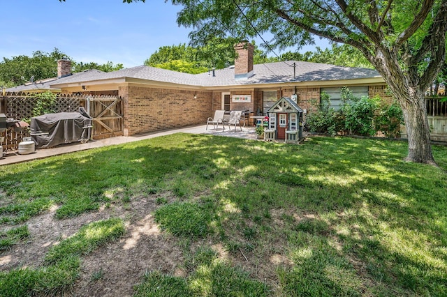 7703 Farrell Dr, Amarillo, TX 79121 - back of house with a patio area, brick siding, and a chimney