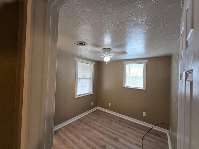 1313 Skyline Dr, Amarillo, TX 79108 - empty room featuring light wood-style flooring, a textured ceiling, and a ceiling fan
