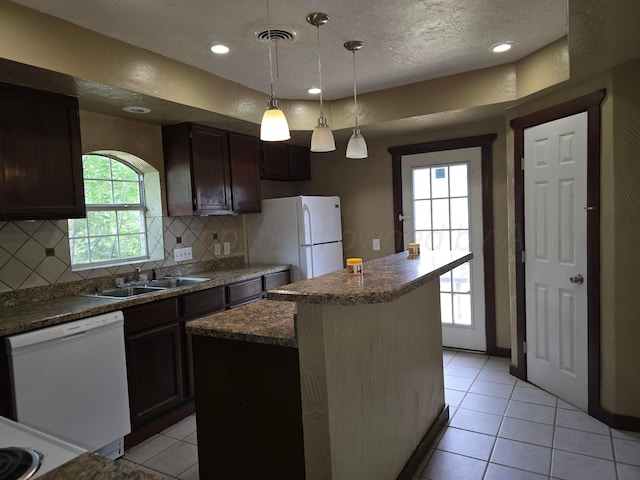 1313 Skyline Dr, Amarillo, TX 79108 - kitchen featuring white appliances, a sink, decorative backsplash, light tile patterned flooring, and a center island