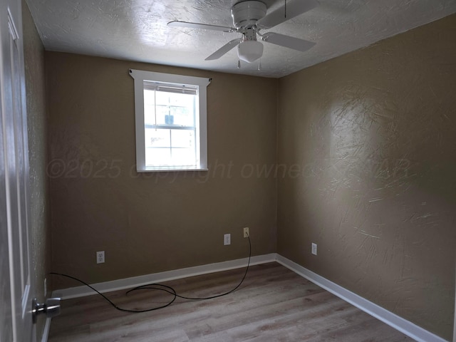1313 Skyline Dr, Amarillo, TX 79108 - spare room featuring wood finished floors, a ceiling fan, and baseboards