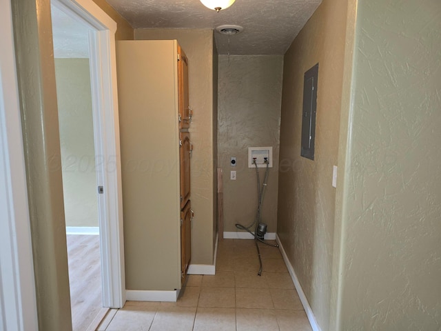 1313 Skyline Dr, Amarillo, TX 79108 - hall featuring a textured wall, electric panel, light tile patterned flooring, a textured ceiling, and baseboards