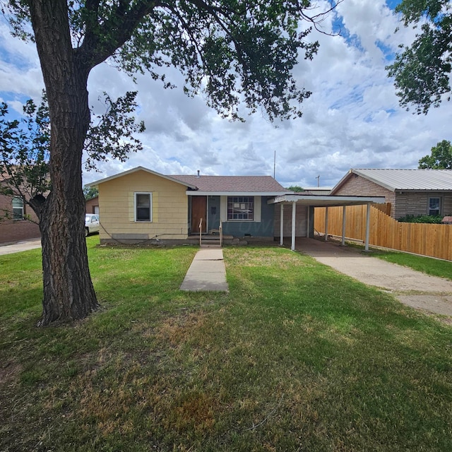 1206 Durrett Ave, Dumas, TX 79029 - view of front of home with driveway and a carport