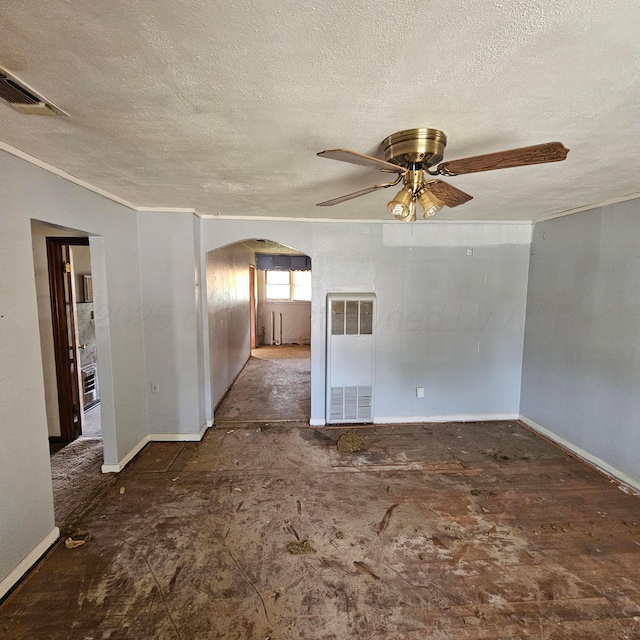 1206 Durrett Ave, Dumas, TX 79029 - unfurnished room featuring arched walkways, a heating unit, a textured ceiling, a ceiling fan, and crown molding