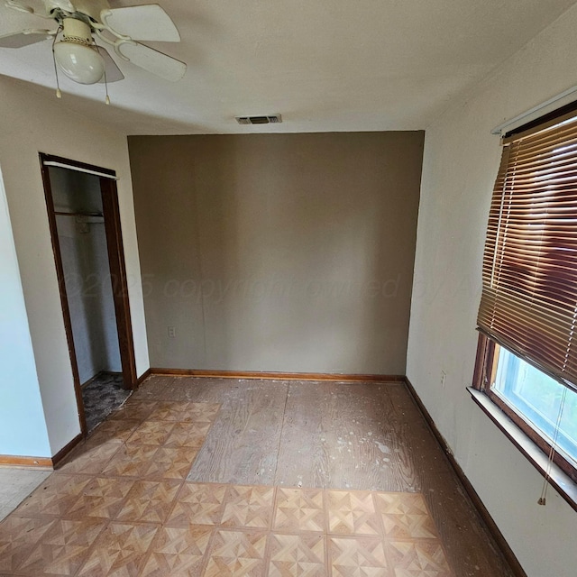 1206 Durrett Ave, Dumas, TX 79029 - unfurnished bedroom with parquet flooring and ceiling fan