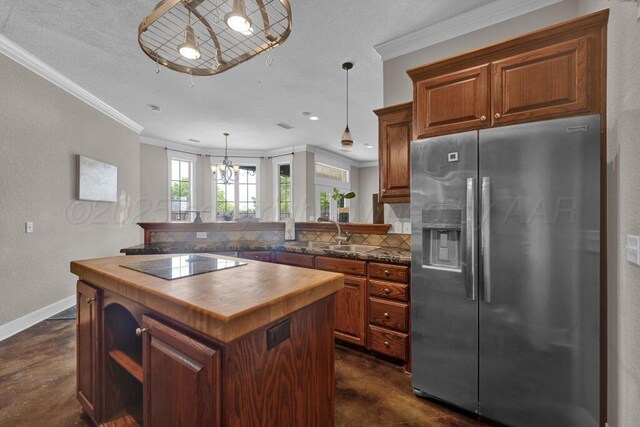 6414 Persimmon Ln, Amarillo, TX 79124 - kitchen featuring stainless steel fridge with ice dispenser, black electric cooktop, crown molding, finished concrete flooring, and decorative backsplash