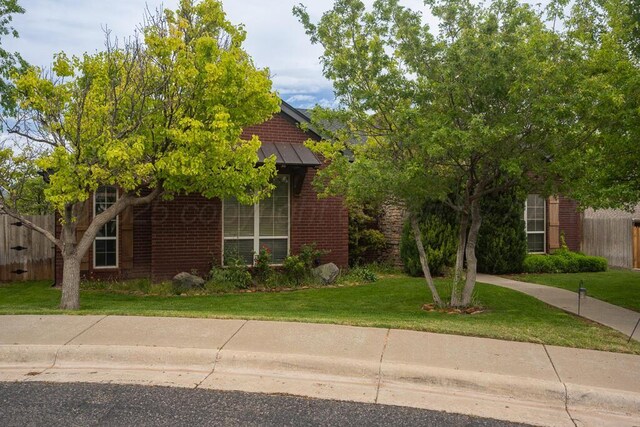 6414 Persimmon Ln, Amarillo, TX 79124 - obstructed view of property with brick siding, a standing seam roof, and metal roof